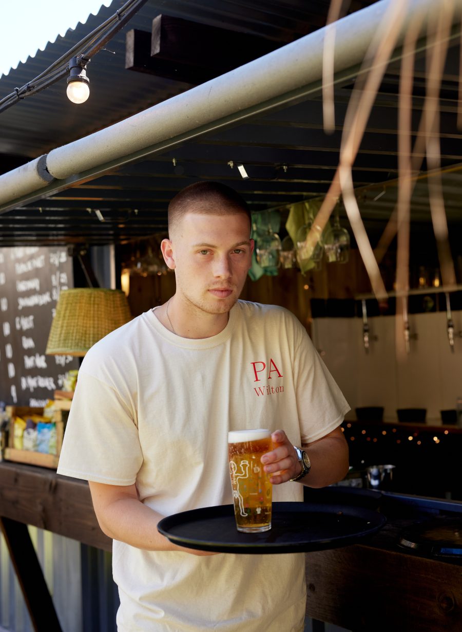 guest holding pint of beer