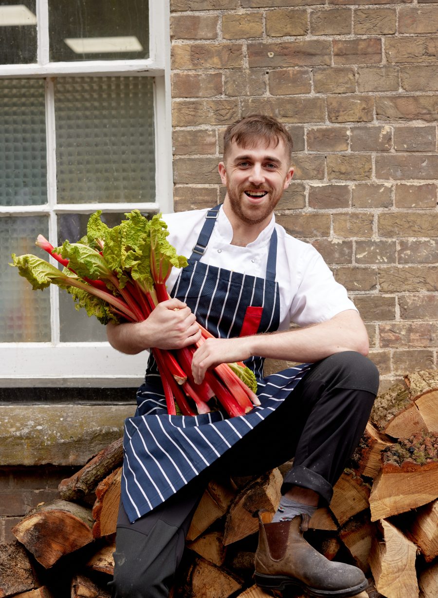 kitchen staff holding seasonal vegetables