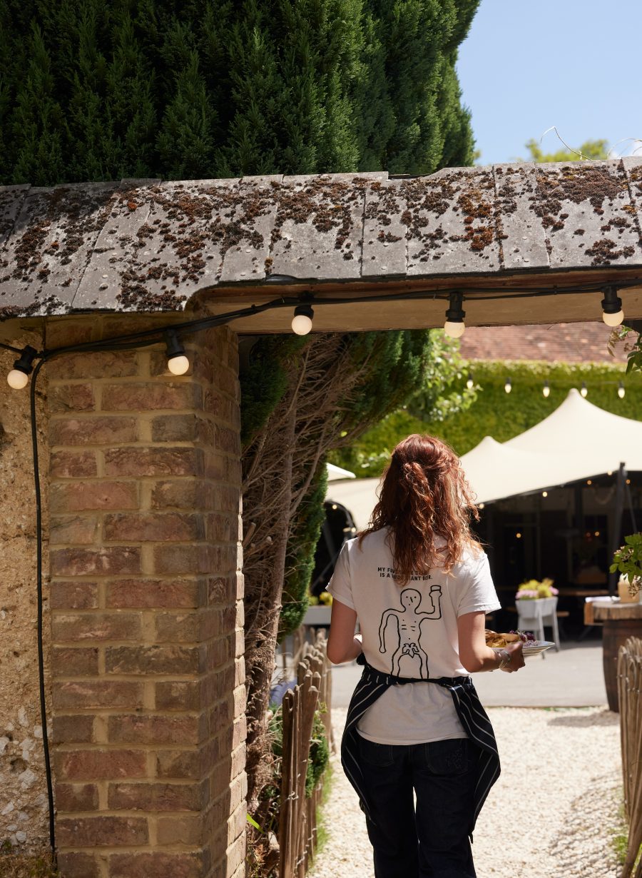 pub staff walking through exterior space