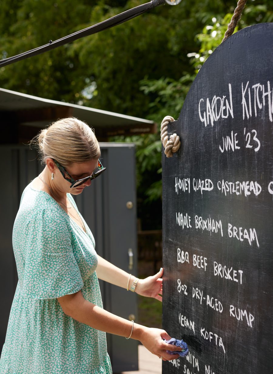 staff member writing restaurant menu